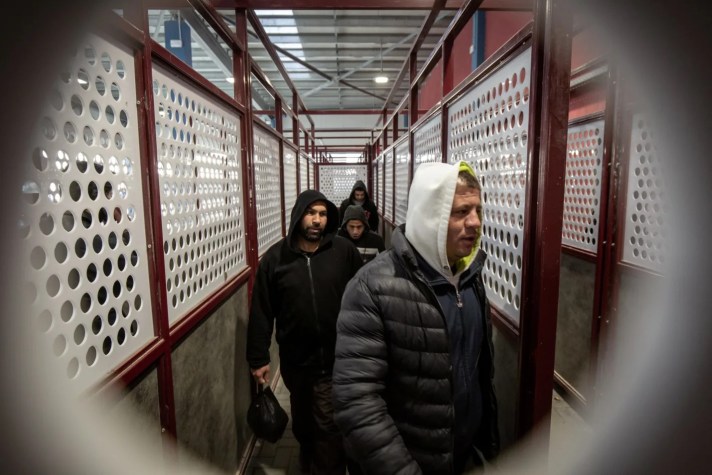 Palestinians pass through the Qalandiyah Crossing near Jerusalem to enter Israel, in March 2019. Credit: Emil Salman [Haaretz]