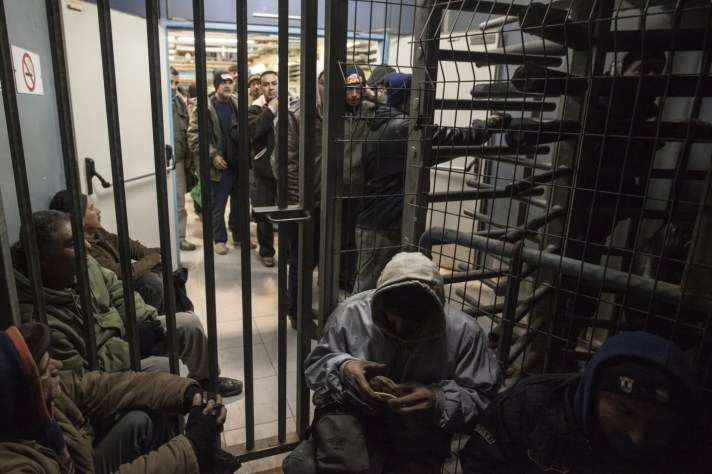 Palestinians crossing the Sha'ar Efraim checkpoint separating Israel and the West Bank.Credit: Tomer Appelbaum [Haaretz]