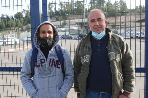 Ahmad Atawneh (r) and Haidar Atawneh (l), Palestinian workers from from the village of Beit Kahel, at the Tarqumiya checkpoint, the West Bank. (Photo: Activestills)