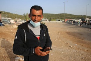Mahmoud Awad, a Palestinian worker, at the Tarquimya checkpoint near Hebron, the West Bank. (Photo: Activestills)