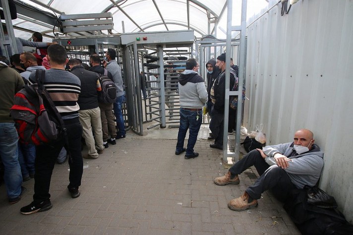 Palestinian workers in line to receive COVID-19 vaccinations at the Qalqilya checkpoint, the West Bank. (Photo: Activestills)